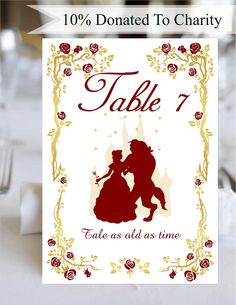 a table card with the silhouette of a man and woman kissing in front of a castle