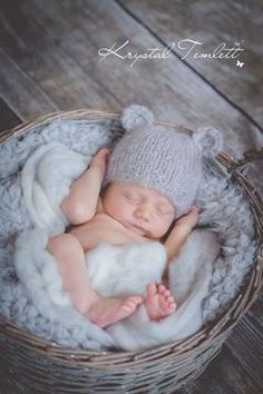 a newborn baby is sleeping in a basket