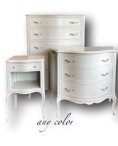 three white dressers with gold handles and drawers on each side, one is empty