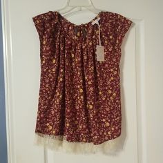 Burgundy Floral Pattern Top. Key Hole Tie Neck On Back. Cream Lace Hem. Pleated Neckline. 100% Polyester. Brand New With Tag. Lace Hem Top, Pleated Neck, Red Floral Print V-neck Top, Red Bohemian Embroidered V-neck Top, Pleated Neckline, Lace Hem, Burgundy Floral, Hem Top, Cream Lace