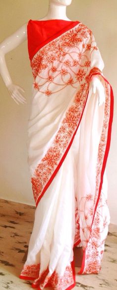 "Stunning half white semi silk saree with intricate all over embroidery and semi raw silk unstiched blouse in reddish orange. The red color thread embroidery is simply stunning aginst offwhite. The entire embroidery is hand worked and the floral border extends more in the front, pallu and the pleats. Saree length 5.5 meters Blouse fabric 1 meter 44\" wide Saree ships in 2-3 days of payment. Delivery within 4-5 days of shipment all over the world. We also offer blouse and petticoat stitching for Traditional White Pre-draped Saree With Embroidered Border, Embroidered White Pre-draped Saree For Festivals, White Silk Traditional Wear With Floral Embroidery, Traditional Red Embroidered Pre-draped Saree, Traditional Red Pre-draped Embroidered Saree, White Silk Pre-draped Saree For Festivals, Traditional Red Pre-draped Saree With Resham Embroidery, White Cutdana Pre-draped Saree For Puja, White Floral Embroidered Pre-draped Saree For Wedding