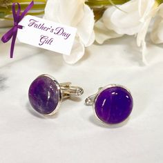 These beautiful cufflinks feature polished natural raw Amethyst cabochons and are perfect for a Father's Day Gift. Set in silver plated settings. Approximate diameter 16mm. Maybe add a match Amethyst Key Ring or Key Fob for something a bit extra... These cabochons are natural products so each amethyst cufflinks set will be unique and variations will occur. Boxed in a luxury box with magnetic closure. All of our jewellery boxes are eco friendly and FSC certified. See our complete range of Amethys Classic Polished Gemstones For Gift, Classic Polished Gemstones For Gifts, Classic Polished Gemstones As A Gift, Classic Handmade Gemstones For Gifts, Handmade Classic Gemstones For Gifts, Classic Handmade Gemstones As Gifts, Polished Amethyst Gemstones For Formal Occasions, Formal Polished Amethyst Gemstones, Adjustable Amethyst Gemstone For Gift