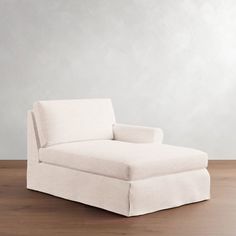 a white couch sitting on top of a wooden floor