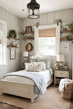 a white bed sitting in a bedroom next to a window with lots of shelves on the wall