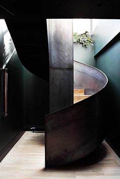 a curved metal staircase in a dark room