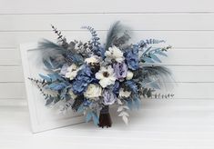 a bridal bouquet with blue and white flowers