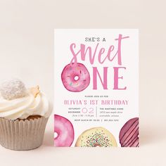 there is a cupcake with frosting and sprinkles next to the birthday card