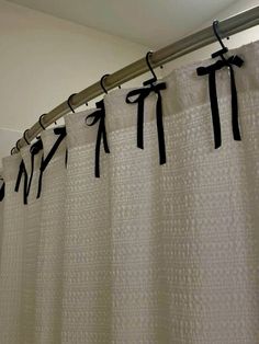 a shower curtain with black ribbon on it