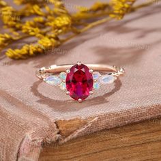 an oval shaped red stone ring on top of a book