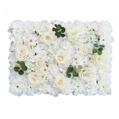 white flowers are arranged on the side of a wall