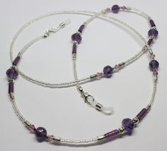 "A lovely glasses chain made using purple tones crystal and glass beads. The glasses chain measures approximately 28\" in length and is finished with rubber ends to securely attach your reading glasses or sunglasses. Very striking and beautiful chain. Lovely gift idea. Wrapped in tissue paper and presented in an organza pouch." Adjustable Single Strand Glass Crystal Necklace, Adjustable Beaded Glass Crystal Necklaces, Purple Glass Beaded Chain Jewelry, Adjustable Purple Glass Beaded Necklaces, Purple Glass Beaded Necklaces With Round Beads, Adjustable Glass Crystal Necklace With Beaded Chain, Purple Glass Beaded Necklace With Round Beads, Adjustable Glass Gemstone Beads, Handmade Purple Glass Beaded Necklaces