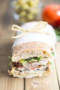 a sandwich cut in half sitting on top of a wooden table