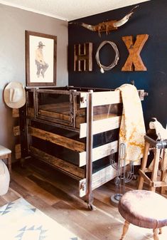 a room with a dresser, chair and pictures on the wall