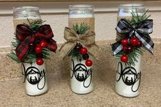 three mason jars decorated with christmas decorations