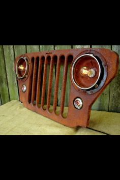 an old rusted radiator sitting on top of a wooden table