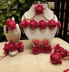 a table topped with pink flowers and jewelry