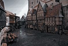 an old european village with cobblestones and half - timbered buildings on either side