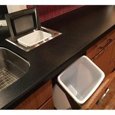 a kitchen counter with a sink, microwave and dishwasher in it's center