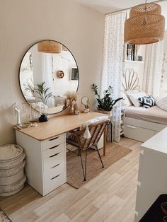 a bedroom with a bed, desk and mirror on the wall next to a window