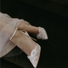 a close up of a person's legs wearing wedding shoes