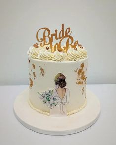 a wedding cake decorated with gold and white frosting