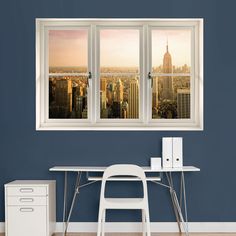 an office with a desk, chair and window overlooking the empire building in new york city