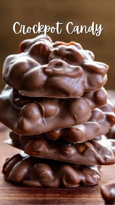 a stack of chocolate covered candy on top of a wooden table with text overlay