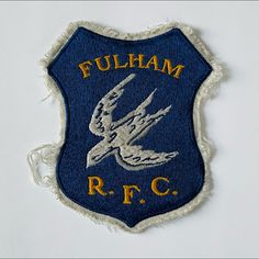 an embroidered patch on the side of a white wall that says fulbham rc