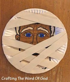 a paper plate with an image of a man's face taped to it