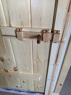 a close up of a door handle on a wooden door