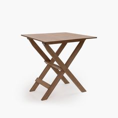 a small wooden table sitting on top of a white floor