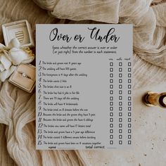 a wedding checklist with rings on top of it next to an open ring box