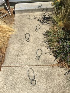 the sidewalk has footprints drawn on it