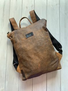 "Brown Leather Backpack, Leather Backpack Purse, Convertible Backpack Cognac leather backpack is made from upcycled cognac leather. For all occasions and inspiring adventures. Zip it and you will find natural lining with open and zipped pocket inside. Convertible backpack can be used as clutch, just roll it.  Minimalist design leather backpack fits 13\" laptop.  |Details| |MATERIAL: upcycled leather. |COLOR: cognac, please note, that colors may vary due to computer monitor's settings and lighten Leather Backpack Purse, Brown Leather Backpack, Minimalist Backpack, Upcycled Leather, Convertible Backpack, Backpack Purse, Inside Pocket, Leather Backpack, Convertible