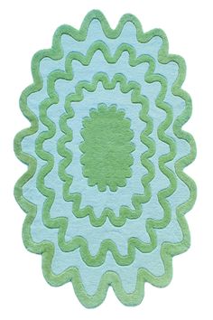 a green and blue rug with an intricate design