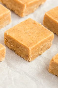 several pieces of peanut butter fudge on top of parchment paper with one piece cut in half