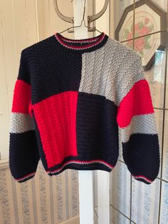 This sweater was hand knit from the softest cotton blend yarn, in dark navy blue, medium grey and vibrant red. The measurements, taken with the sweater lying flat, are: shoulder to shoulder,  16 inches; armpit to armpit, 18 inches; sleeves, 18 inches; length, 17 inches; bottom edge, 11 inches (with very stretchy ribbing). In very good condition. Colour Block Sweater, Sweater Handmade, Handmade Sweater, Kids Jumpers, Color Block Sweater, Dark Navy Blue, Vintage Button, Knit Pullover, Kids Sweater