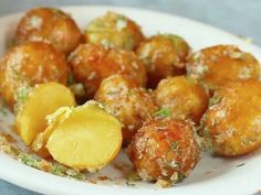 a white plate topped with fried potatoes and parmesan cheese