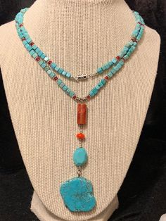 This beautiful necklace was made with square turquoise and round carnelian beads. The charm is also turquoise and carnelian and really pulls the red beautiful from the necklace. Turquoise is said to help the wearer live a life of integrity and to bring balance to our feminine or masculine traits. Artisan Turquoise Adjustable Lariat Necklace, Artisan Turquoise Lariat Necklace Adjustable, Artisan Adjustable Turquoise Lariat Necklace, Bohemian Adjustable Necklace With Square Pendant, Bohemian Necklace With Adjustable Square Pendant, Bohemian Style Adjustable Necklace With Square Pendant, Turquoise Rectangular Adjustable Necklace, Adjustable Rectangular Turquoise Necklace, Bohemian Turquoise Rectangular Necklace