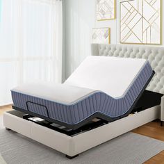 a bed with a mattress on top of it in a room next to a window