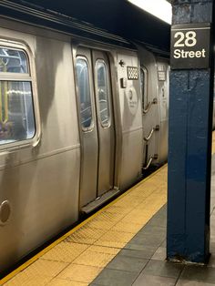 a subway train stopped at the station with its doors open