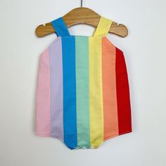 Baby retro rainbow romper. Poppers for easy changing, relaxed fit, plenty of room for nappies (cloth or disposable). Fully lined with light soft cotton. Seamless insides making them comfortable against babies skin. Rainbow design made up of carefully selected colours of 100% premium quality cotton. Adjustable length straps. Multicolor Jumpsuits And Rompers For Spring Playtime, Playful Yellow Cotton Jumpsuits And Rompers, Spring Multicolor Cotton Onesie, Playful Multicolor Bubble Romper For Spring, Spring Multicolor Onesie For Playtime, Multicolor Cotton Onesie For Summer, Cute Multicolor Cotton Bubble Romper, Cute Multicolor Jumpsuits And Rompers For Playtime, Summer Multicolor Cotton Onesie