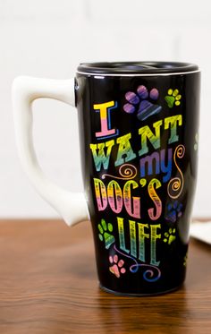 a black coffee mug with the words i want my dog's life printed on it