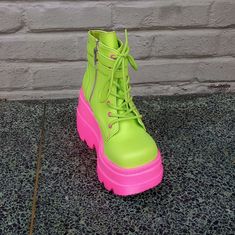 The Demonia Shaker-52 Ankle Boot In Lime Green And Pink Has A 2.5" Platform And 4.5" Heel, Adjustable Front Lacing, Decorative Adjustable Double Straps, And A Side Zip Closure. #Demonia #Demoniashaker #Demoniashaker52 #Shaker52 Trendy Pink Boots For Spring, Pink High Ankle Summer Boots, Pink High Ankle Boots For Summer, Platform Boots For Spring Streetwear, Spring High Ankle Platform Boots With Rubber Sole, Spring Platform Boots With High Ankle And Rubber Sole, Pink Rubber Sole Boots For Spring, Trendy High Ankle Pink Heels, Pink Round Toe Boots For Summer