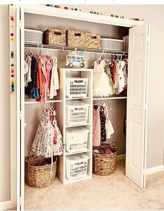 an organized closet with baskets and clothes