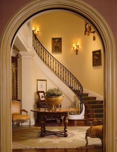 an archway leading to a living room filled with furniture