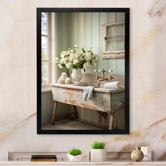 a bathroom sink sitting under a window next to a white vase filled with flowers on top of a counter