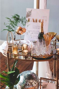 a bar cart filled with champagne and other items