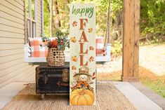 a happy fall sign sitting on top of a porch