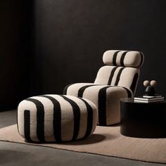 a black and white striped chair sitting on top of a rug